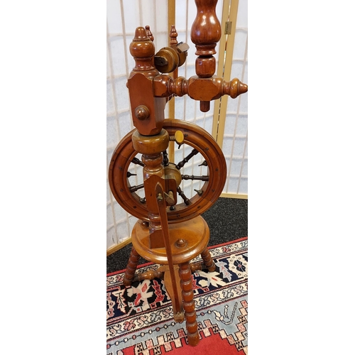 206 - A Victorian arts and crafts bobble leg spinning wheel. [135cm in height]