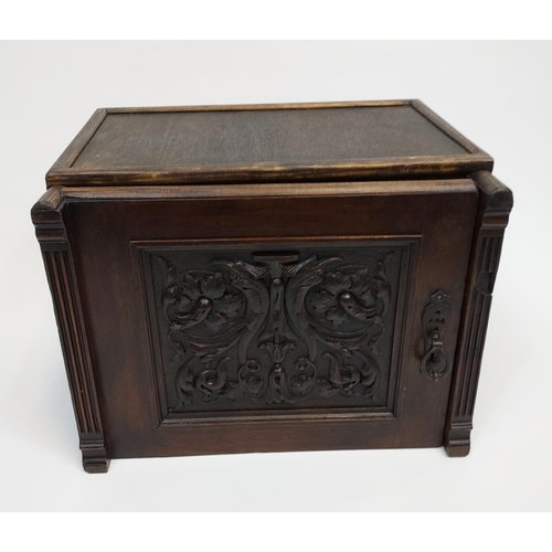 323 - A Miniature Three drawer chest designed with a carved panel door. [27cm in height]