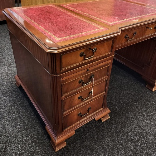 335 - A Large reproduction knee hole partners desk. Designed with a three section red leather top. Two pul... 