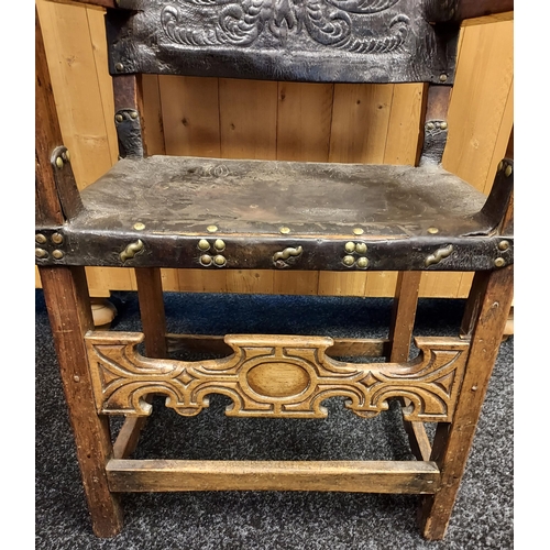 340 - An 18th/ early 19th century fire side arm chair. Leather worked back and seat area.