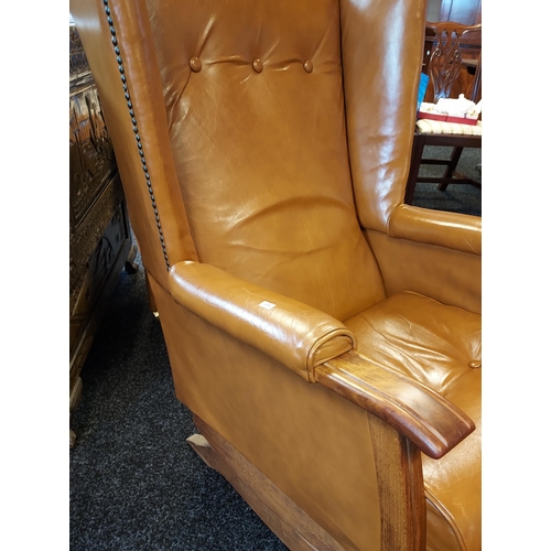 357 - A Vintage/ mid century brown mustard leather rocking arm chair with matching foot stool