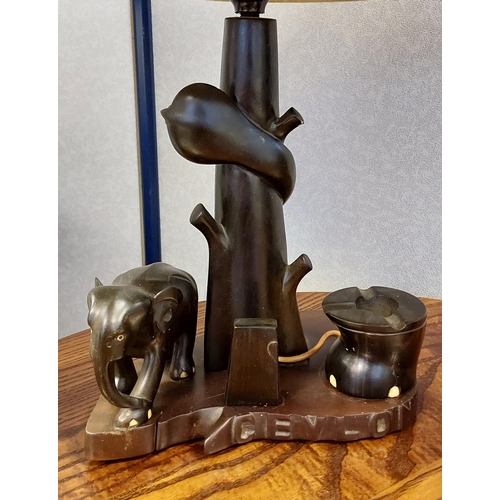 370 - A Japanese hand carved wooden figure table lamp together with an African carved elephant table lamp