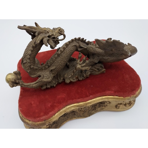 382 - Antique Chinese Qing heavy bronze dragon sculpture. Comes with gilt moulded base. [Dragon measures 9... 