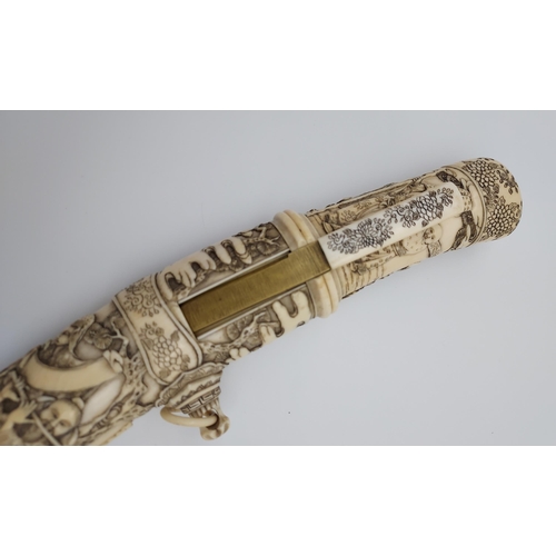 390 - A 19th/ early 20th century highly decorative Japanese Tanto. Carved from ivory. Saya has a smaller b... 