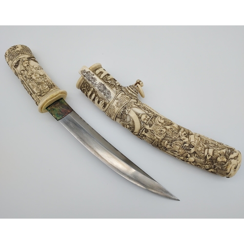 390 - A 19th/ early 20th century highly decorative Japanese Tanto. Carved from ivory. Saya has a smaller b... 