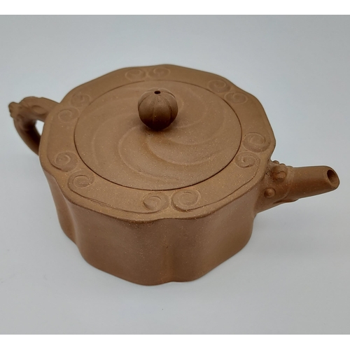 400 - A Chinese Yixing pottery tea pot. [5.5cm in height] Marked to the base and inside of lid.