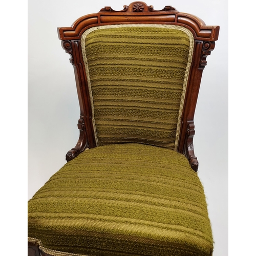 468 - A 19th century bedroom chair designed with a carved wooden frame, turned legs and green upholstery.