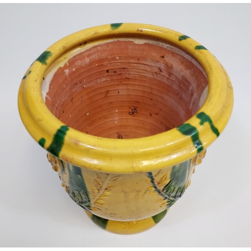 475 - A Large antique Majolica plant pot. Designed in a yellow and green glaze. [31cm in height]