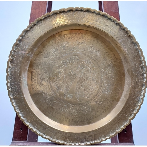 488 - A Gilt brass engraved wall charger depicting dragon/ horse. Made in Hong Kong. [41cm in diameter]