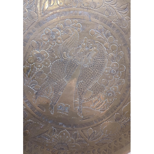 488 - A Gilt brass engraved wall charger depicting dragon/ horse. Made in Hong Kong. [41cm in diameter]