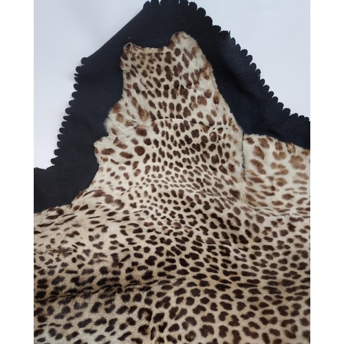 499 - An Antique Leopard skin rug. [260x120cm]