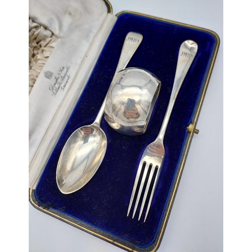 500 - A Boxed London silver three piece Christening set. Fork, spoon and napkin ring.