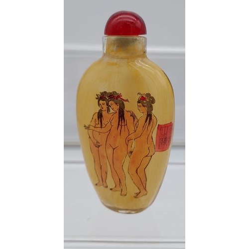 537 - A Chinese hand painted glass perfume bottle showing two nude figures to each side.