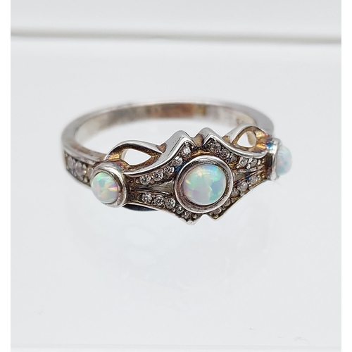 539 - A silver, CZ & opal paneled art nouveau style ring [4.18g]