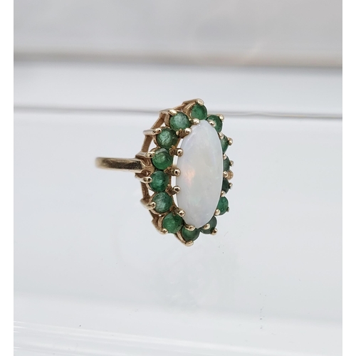 552 - A Beautiful example of a ladies 9ct gold, large opal and emerald cluster ring. [15.2x7.0mm-opal]