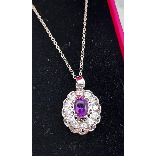 553 - A silver & CZ pendant necklace with central amethyst panel