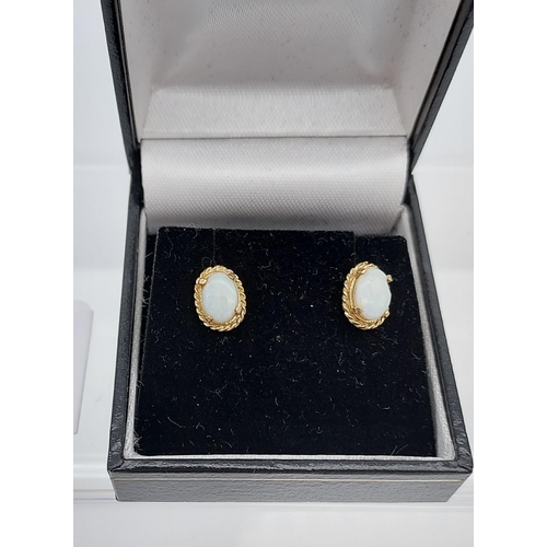 555 - A Pair of 9ct gold and opal earrings.