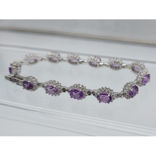 562 - A silver CZ & amethyst bracelet