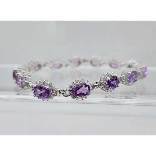 562 - A silver CZ & amethyst bracelet