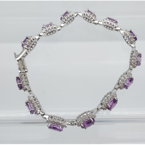 562 - A silver CZ & amethyst bracelet