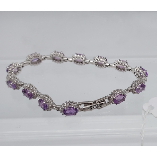 562 - A silver CZ & amethyst bracelet