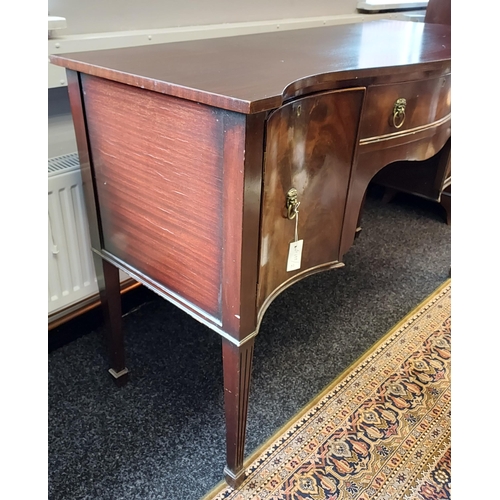 85 - A 19th century serpentine front sideboard. supported on square tapered legs. Brass lion head handles... 