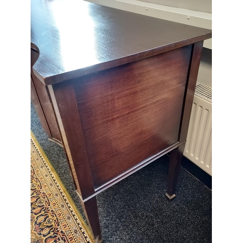 85 - A 19th century serpentine front sideboard. supported on square tapered legs. Brass lion head handles... 