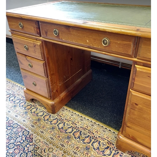 88 - A Pine Ducal knee hole writing desk with green leather top [75x120x60cm]