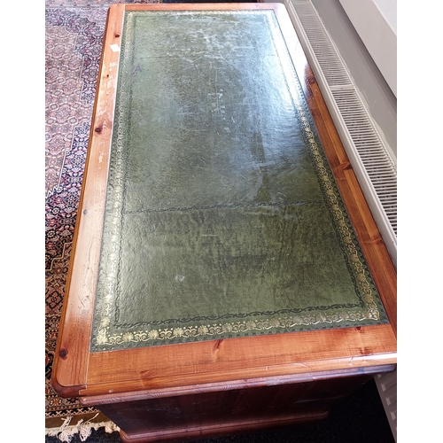 88 - A Pine Ducal knee hole writing desk with green leather top [75x120x60cm]