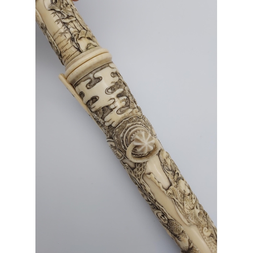 390 - A 19th/ early 20th century highly decorative Japanese Tanto. Carved from ivory. Saya has a smaller b... 