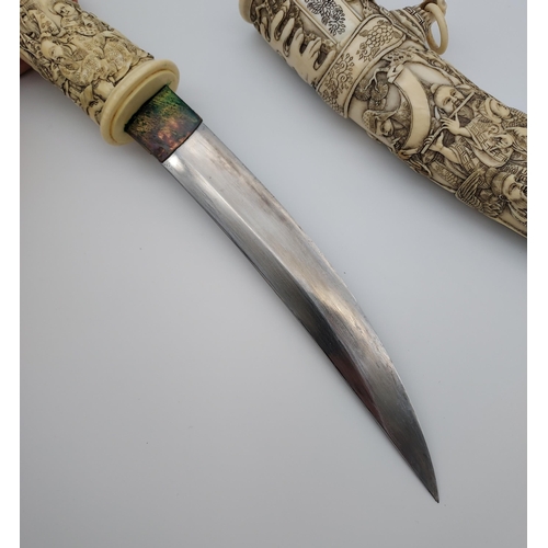 390 - A 19th/ early 20th century highly decorative Japanese Tanto. Carved from ivory. Saya has a smaller b... 