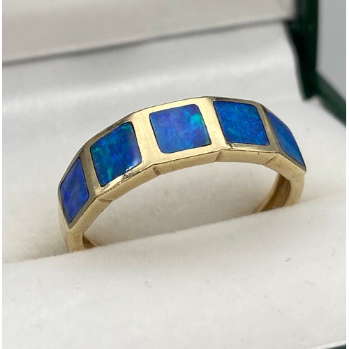 6 - A Ladies 9ct yellow gold ring set with blue opals. [Ring size O] [2.60Grams]