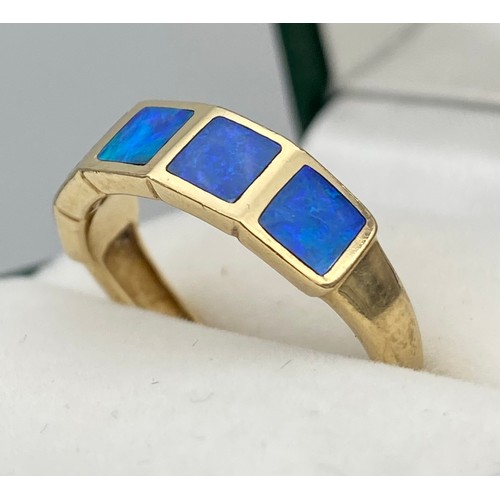 6 - A Ladies 9ct yellow gold ring set with blue opals. [Ring size O] [2.60Grams]