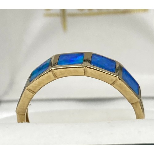 6 - A Ladies 9ct yellow gold ring set with blue opals. [Ring size O] [2.60Grams]