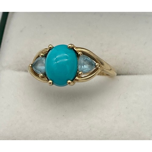 3 - A Ladies 9ct yellow gold ring set with a large Turquoise centre stone, off set by two aqua coloured ... 