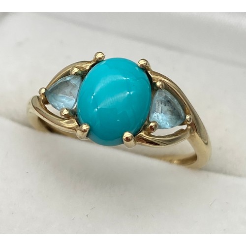 3 - A Ladies 9ct yellow gold ring set with a large Turquoise centre stone, off set by two aqua coloured ... 