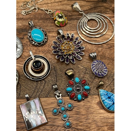 45 - A Collection of contemporary silver pendants [14] with enamel and stone designs.