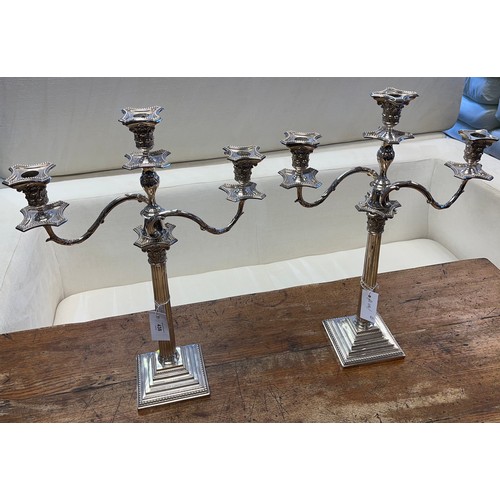 438 - A Large pair of antique Corinthian column candelabras.