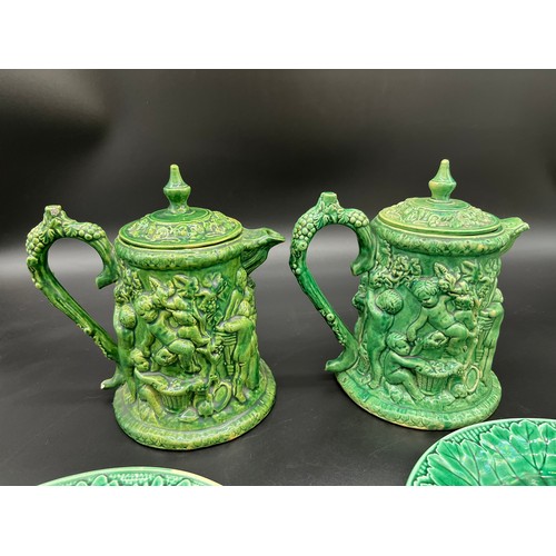 416 - A pair of antique Dunmore pottery coffee pots with raised relief cherub design. Together with Green ... 