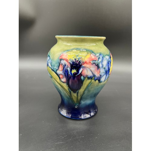 414 - Moorcroft- Potter to H.M. The Queen
Orchids design bulbous vase. Signed to the base. [14.5cm high]