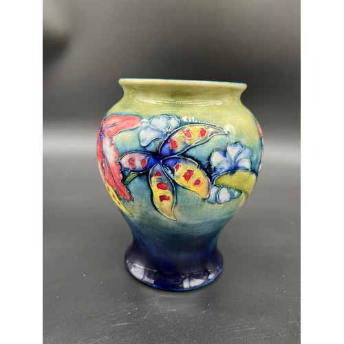 414 - Moorcroft- Potter to H.M. The Queen
Orchids design bulbous vase. Signed to the base. [14.5cm high]