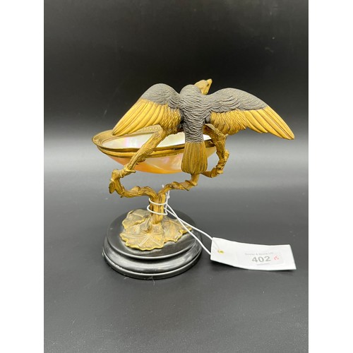 402 - Antique gilt metal and mounted mother of pearl shell, surmounted with an eagle style bird. [15cm hig... 