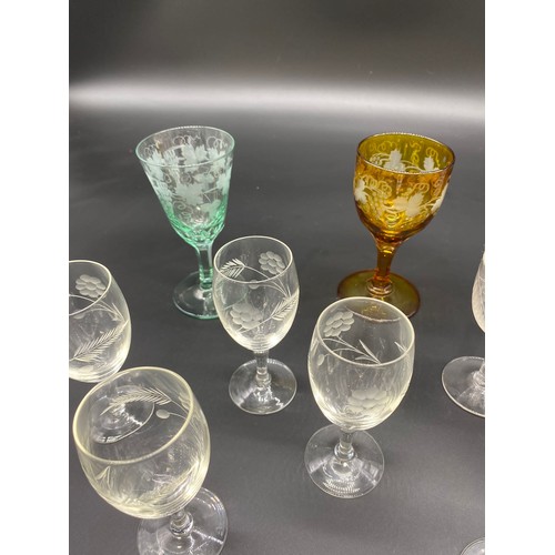 393 - A Lot of etched drinking glasses to include Amber and green glass etched goblets.