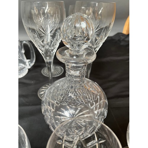 385 - A quantity of cut crystal wine glasses, whisky glasses, facet cut decanter and matching glasses.