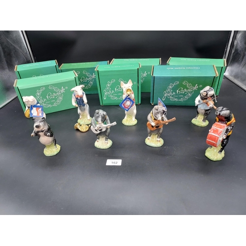 162A - A Lot of eight Beswick pig band figures with original boxes.