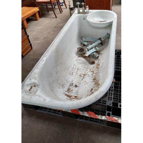 299 - Antique cast metal and enamel bath tub with fitted taps , comes with pedestal legs.