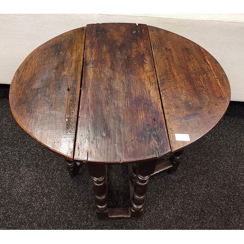 300A - An early 17th century Tudor drop leaf table. [72cm high]