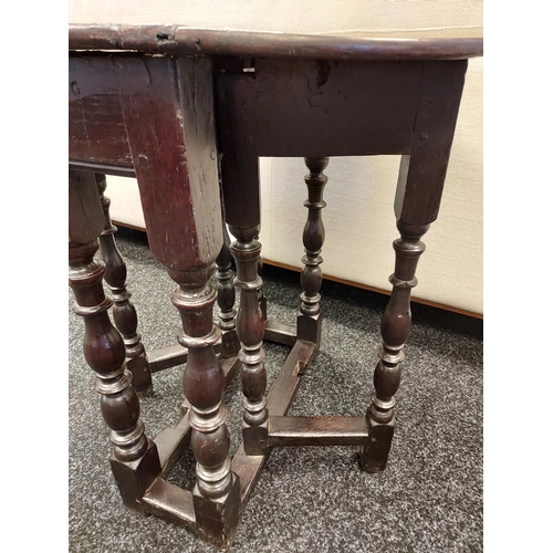 300A - An early 17th century Tudor drop leaf table. [72cm high]