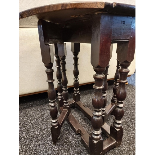 300A - An early 17th century Tudor drop leaf table. [72cm high]