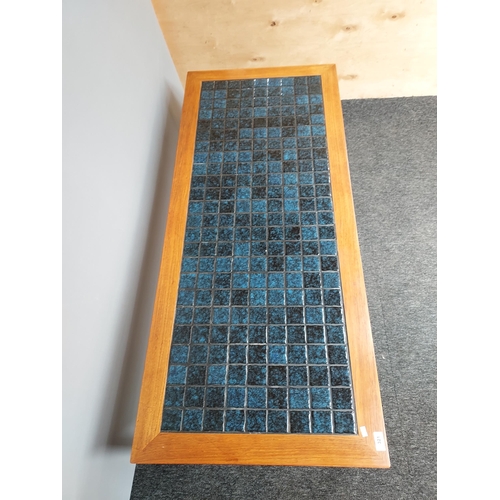 321 - A Mid century teak and blue tile top coffee table. [46x140x61cm]